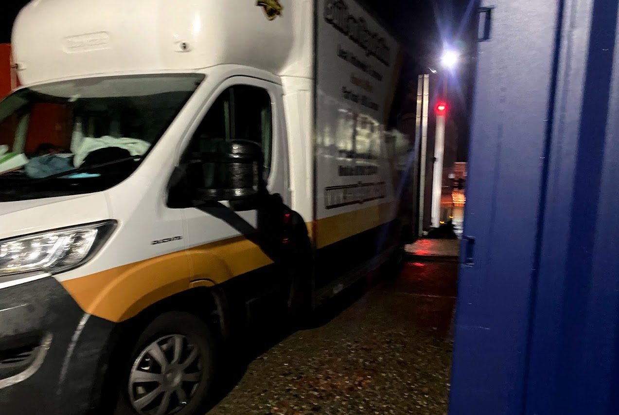 van unloading at night time on illuminated storage facility in carlisle