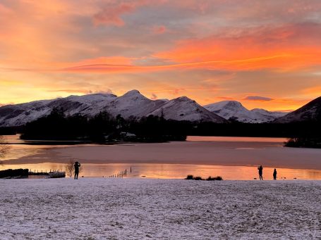 dramatic keswick lake view at sunset with orange sky