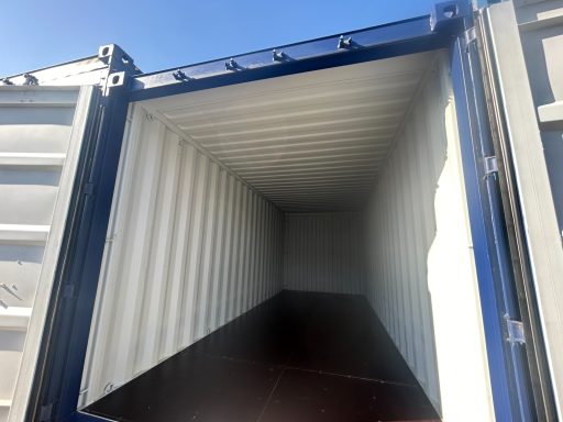 Empty shipping container interior with sunlight illuminating the space.