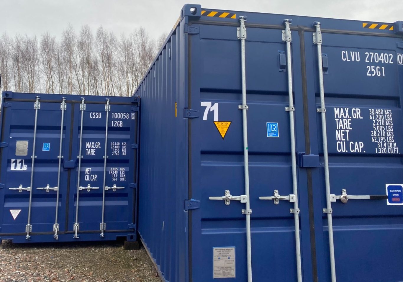 row of 10 foot shipping containers with a car parked beside