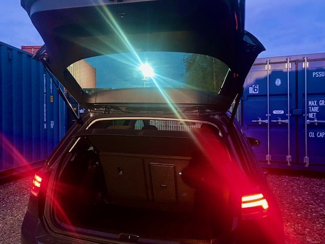 a car unloading on a self storage site during dusk