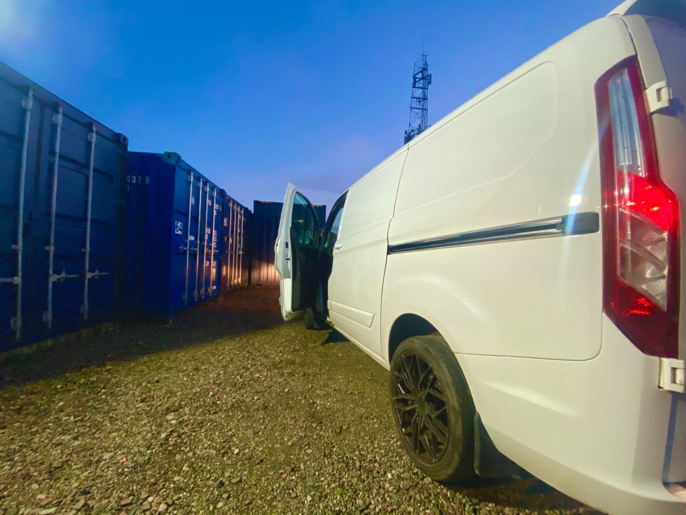 van at dusk on a storage facility