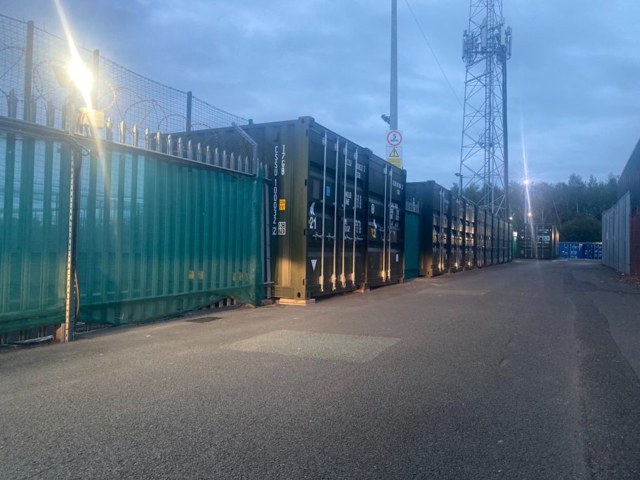 shipping containers at night illuminated with lights