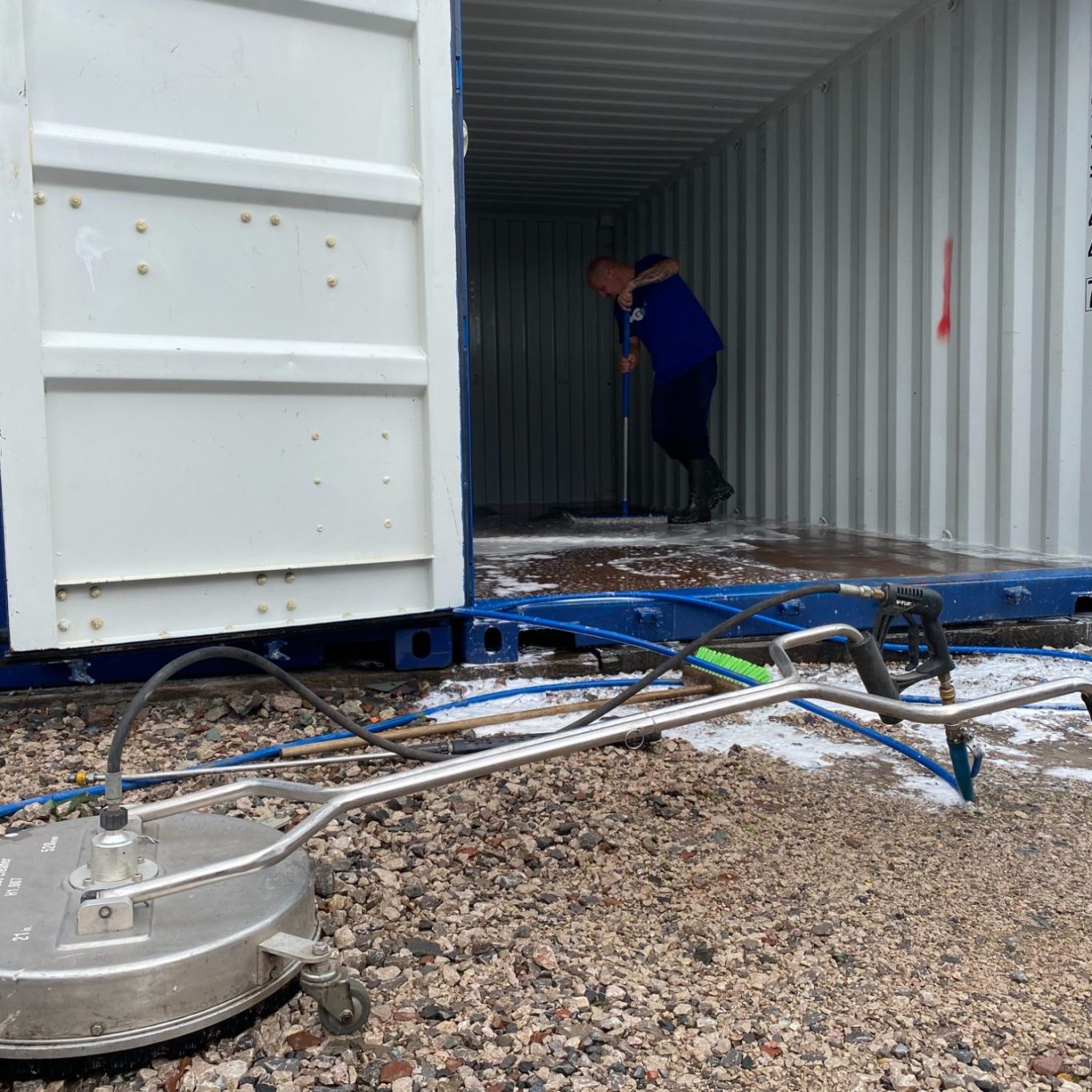 cleaning equipment outside a shipping container