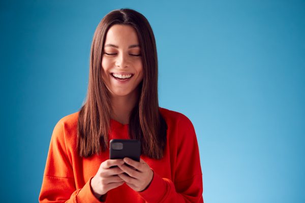happy woman holding a mobile phone