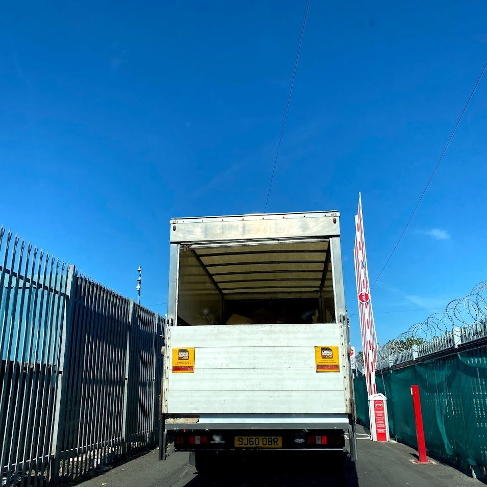 removals vehicle driving through a security barrier on a storage facility