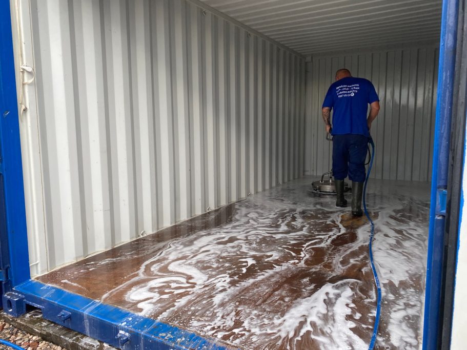 shipping storage container unit being pressure cleaned
