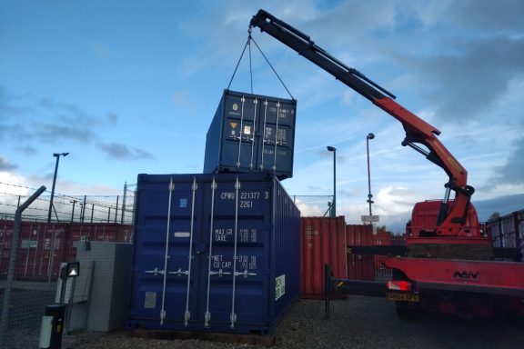 shipping container being delivered by a lorry
