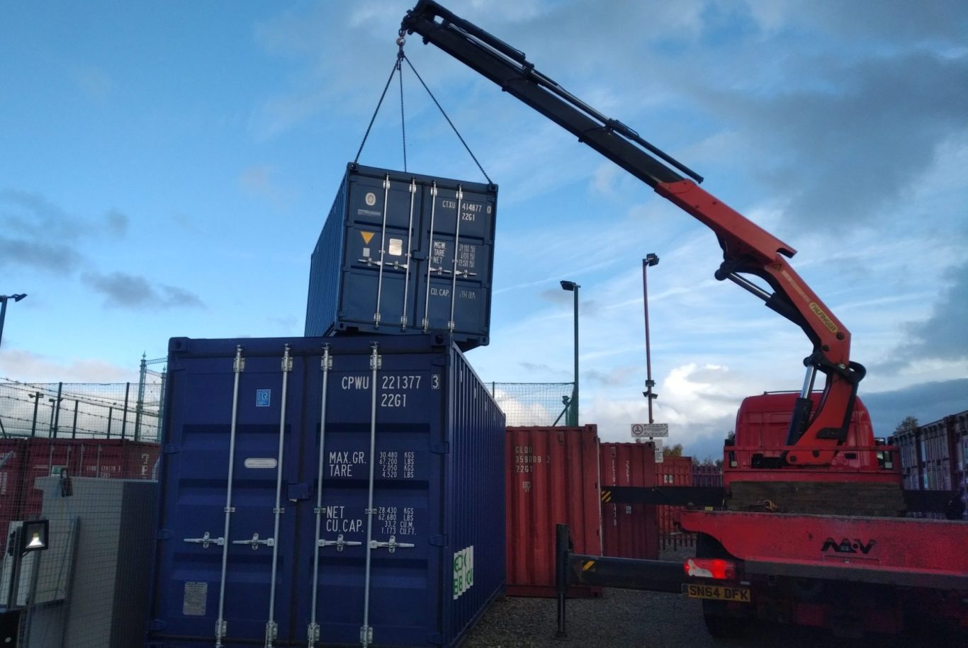 shipping container in the air on a craine