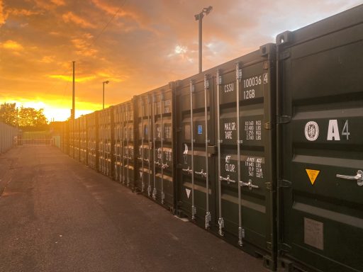 row of shipping containers at sunset