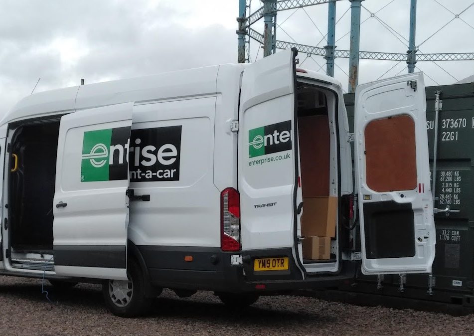 van delivering furniture into a storage facility