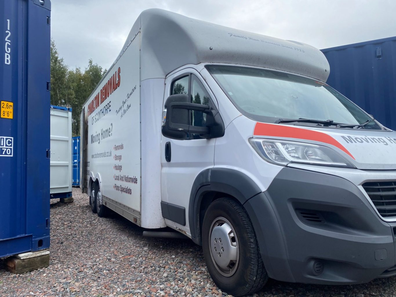 van loading furniture into storage