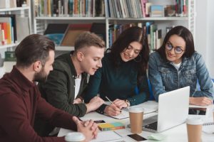 students sat at a desk working