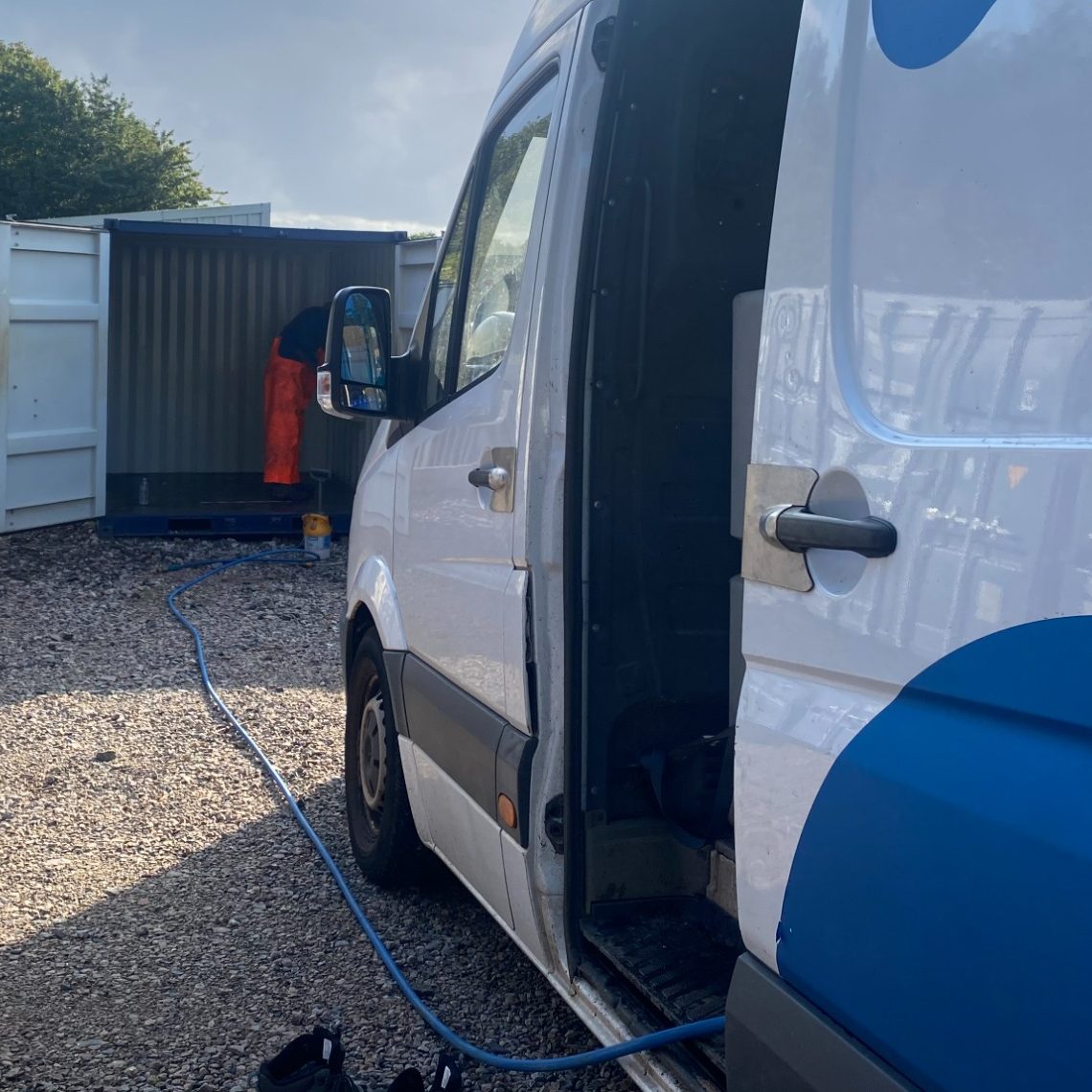a van with pressure washing equipment on a storage site