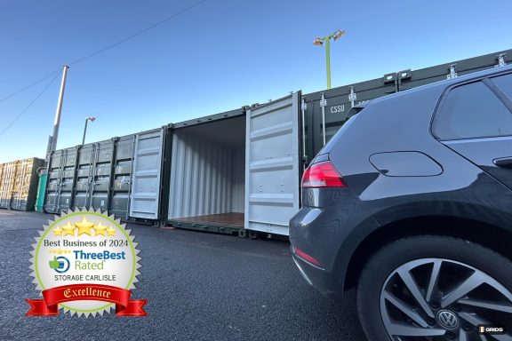 car next to a green shipping container