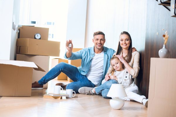 family with daughter moved into home unpacking boxes