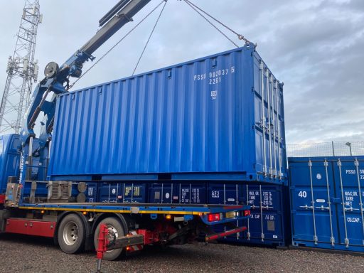 shipping container being delivered to a storage depot