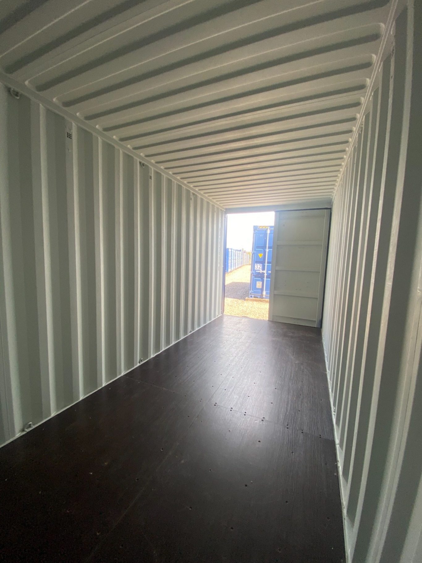 inside of a 20 foot hi cube shipping container with varnished floor