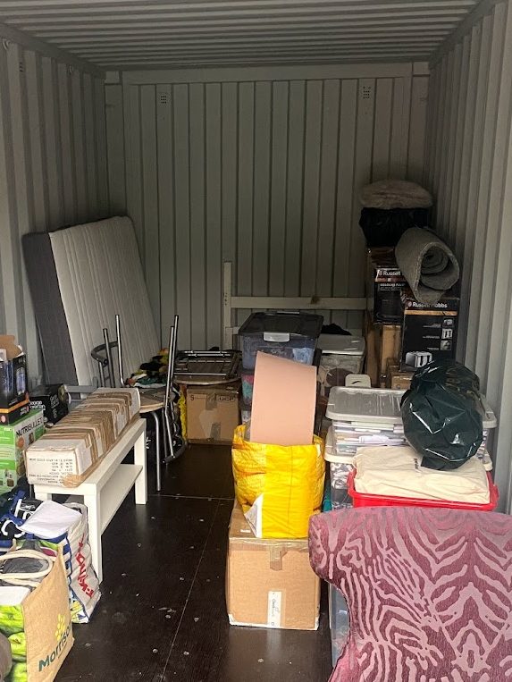 boxes and household furniture in a self storage locker