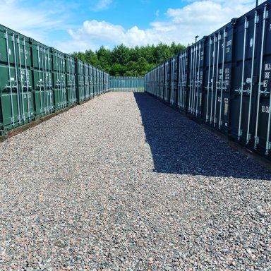 row of green shipping containers