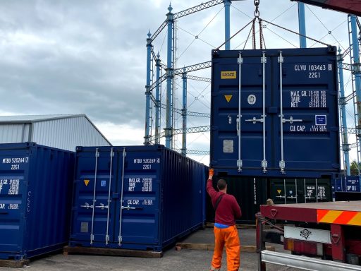 a shipping container being delivered on a hiab