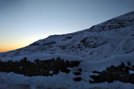 snow on mountain at sun set