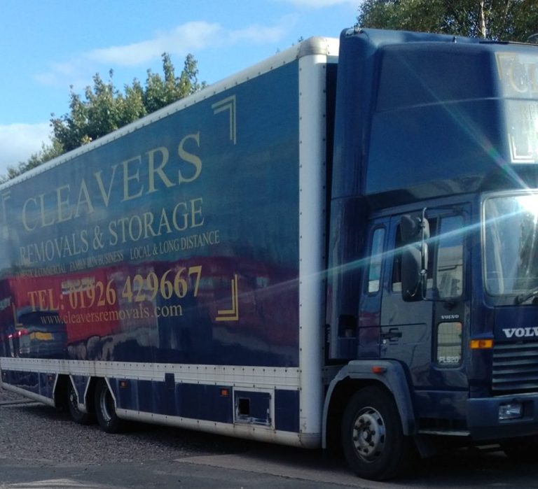 a large blue furniture removals vehicle