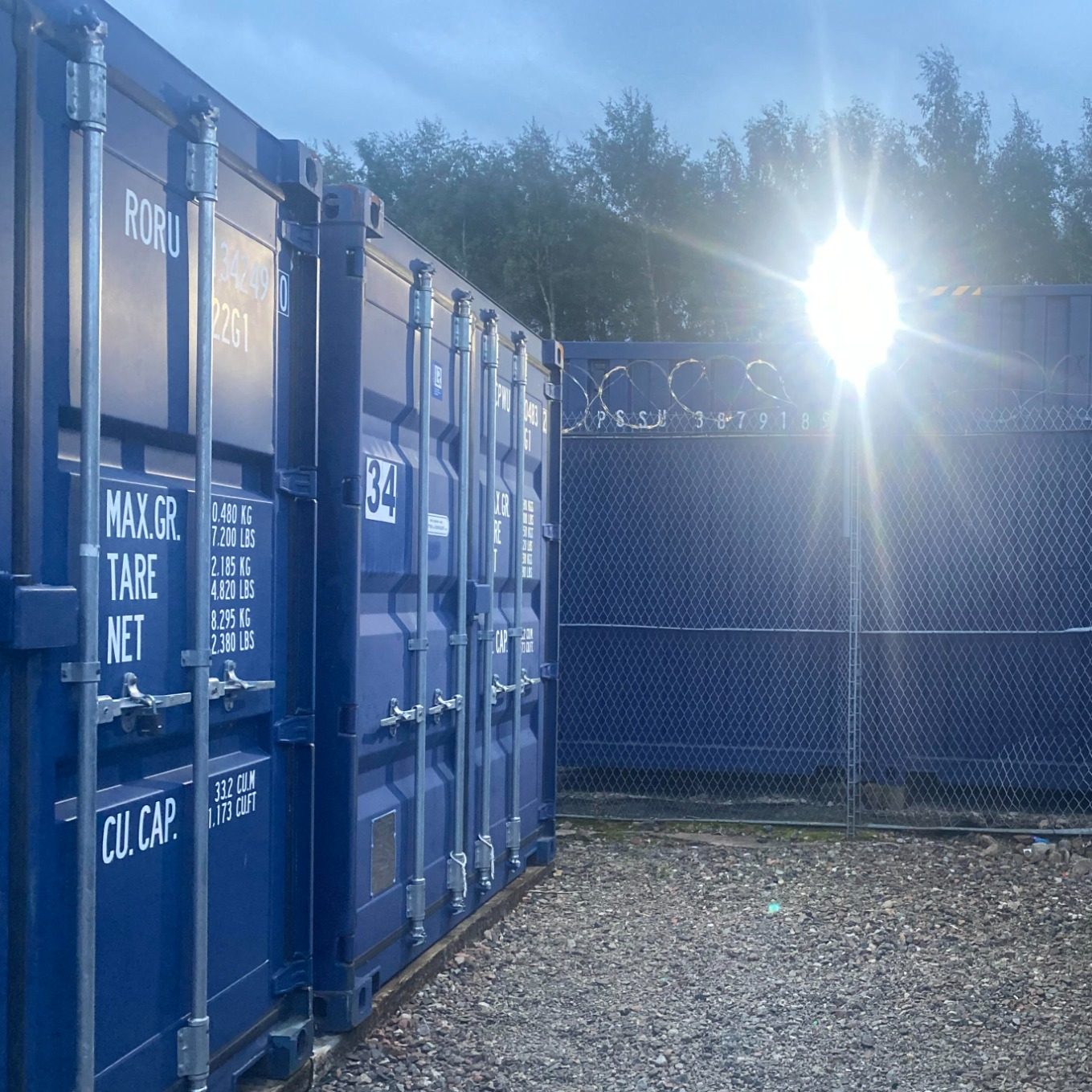 shipping container on self storage site illuminated at night