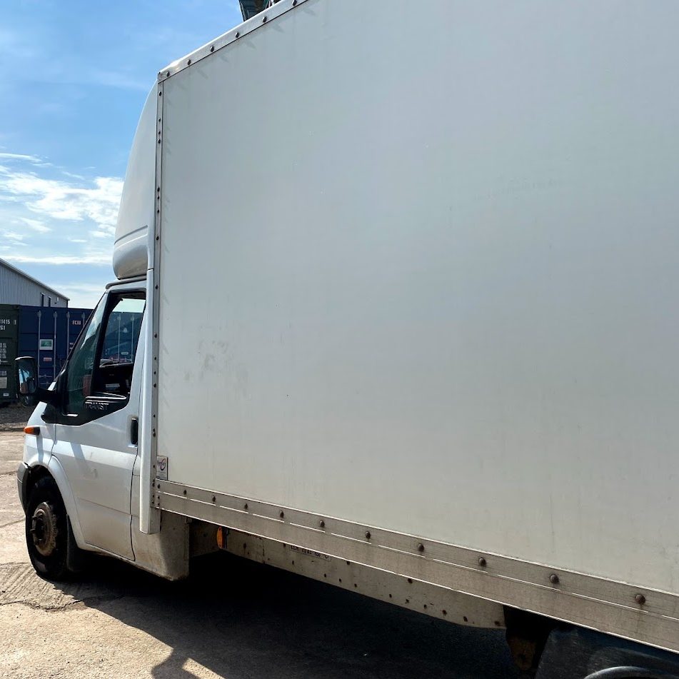 large van driving up to a storage unit