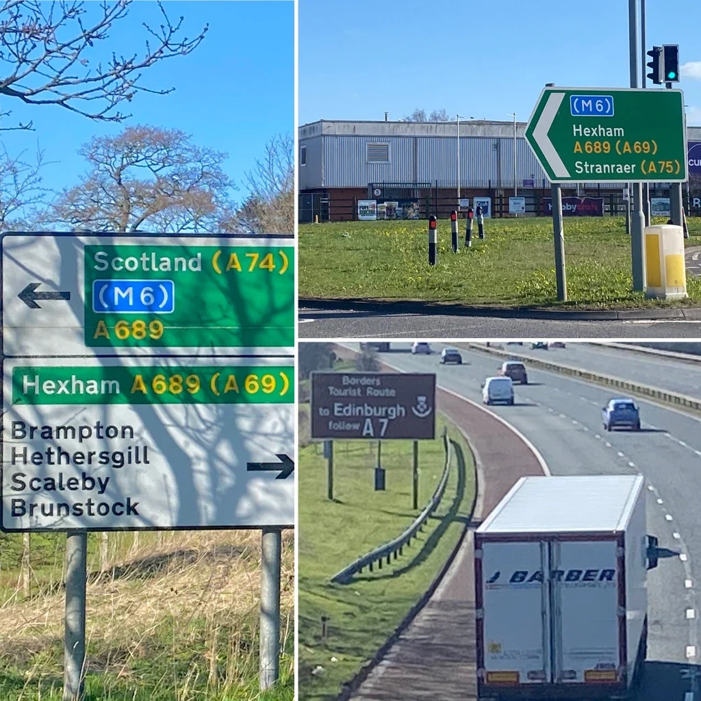 Road signs indicating directions to Scotland and nearby locations, with vehicles on a motorway near Kingstown Industrial Estate in Carlisle.