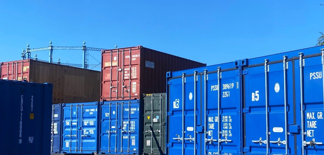a row of shipping containers at a storage depot