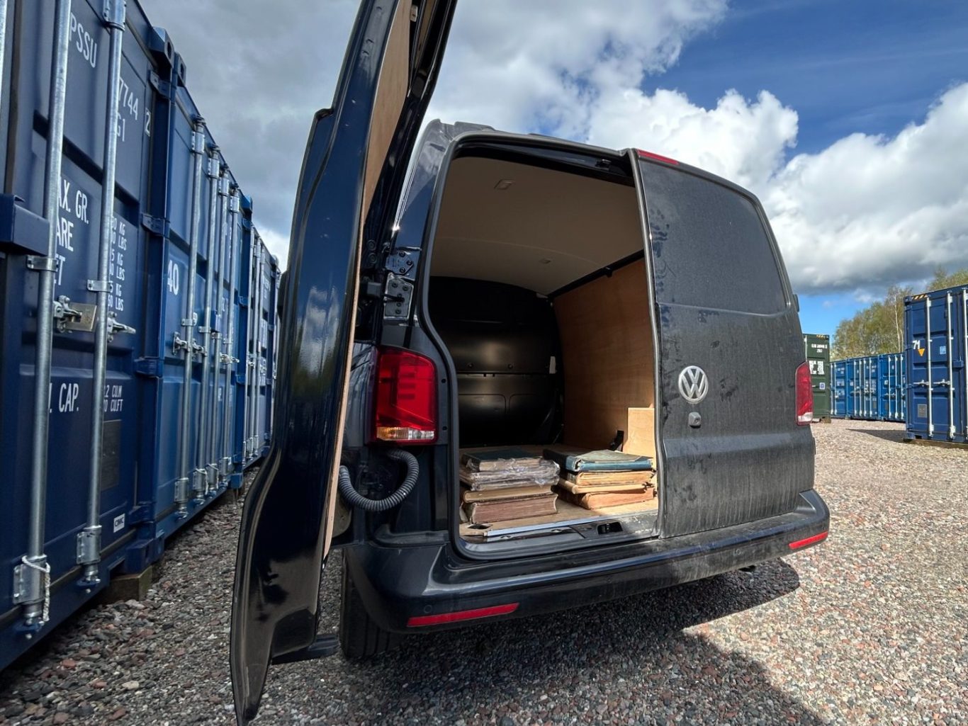 a van unloading personal items into a storage unit