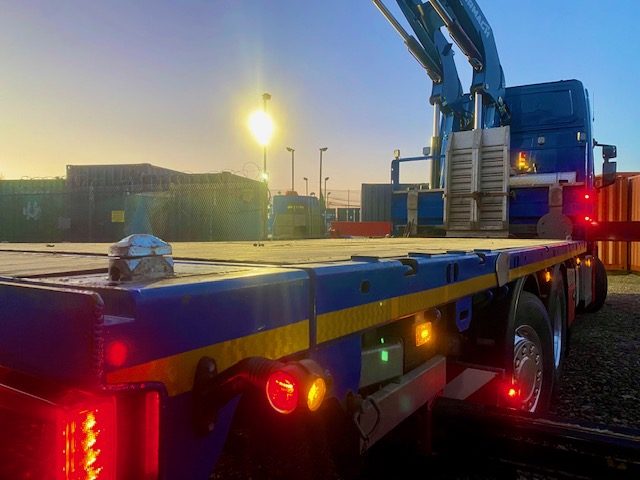 a huge lorry collecting a shipping container