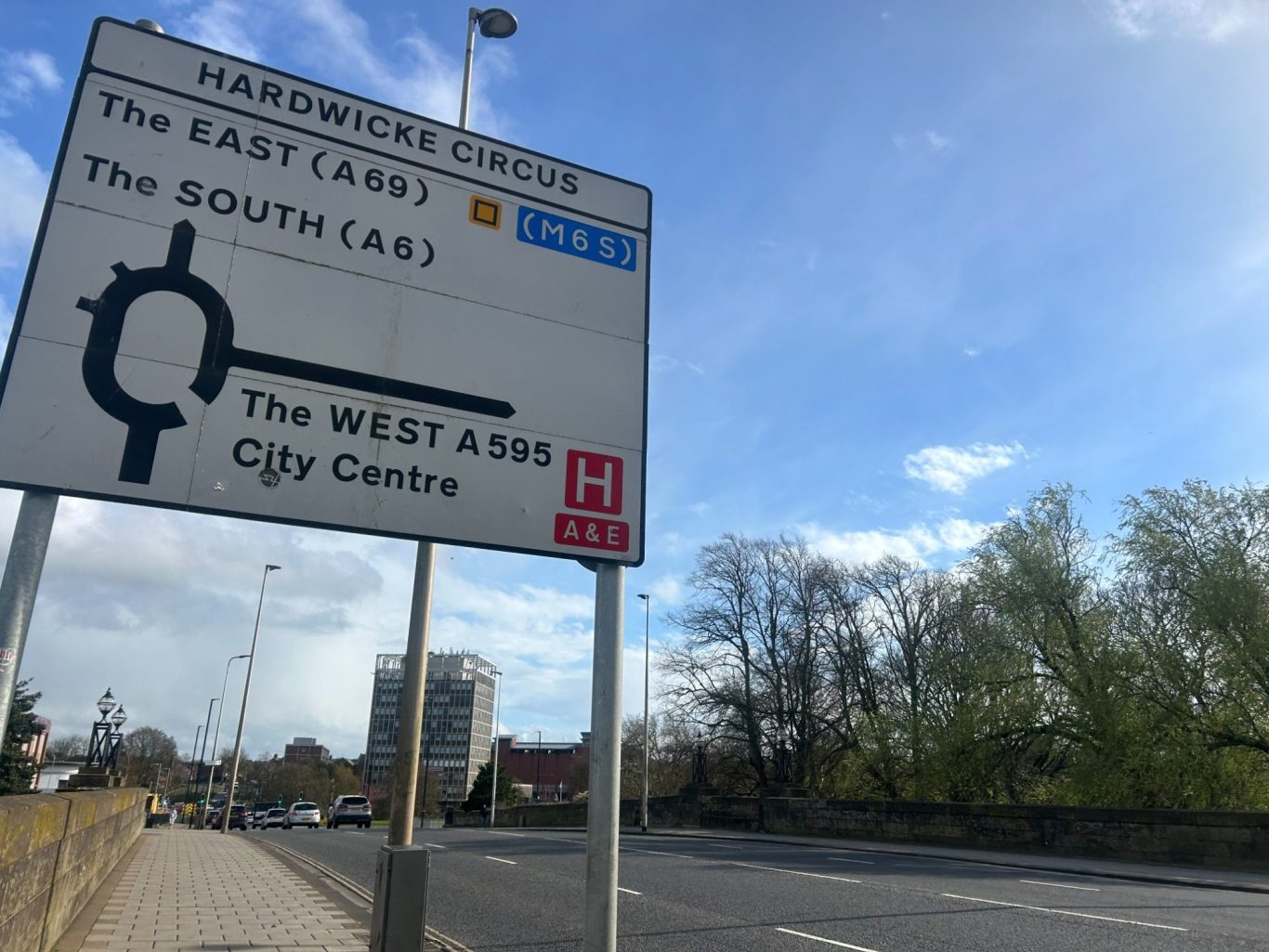 Traffic sign indicating directions to the East, South, and City Centre with clear labels.