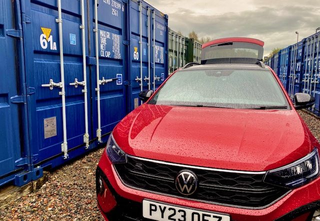 car parked beside a storage locker