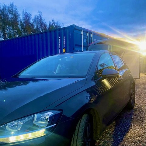 motor car at night on a floodlit storage facility