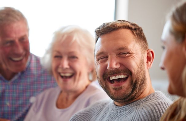 smiling man surrounded by family