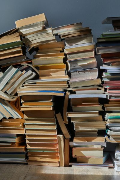 a collection of cluttered books in a pile 