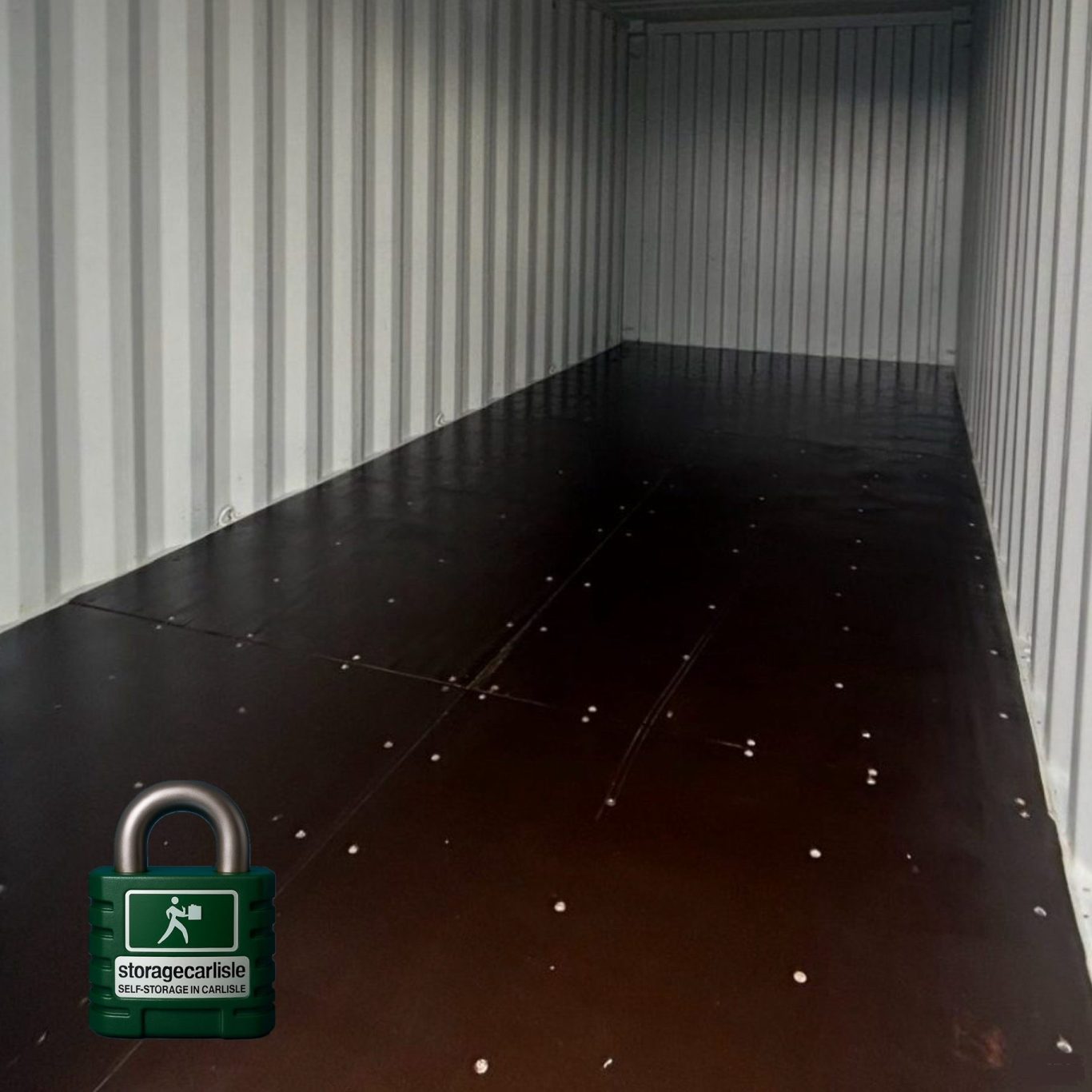 Empty shipping container interior, featuring metal walls and a brown floor.
