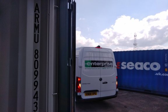 enterprise van at a shipping container depot