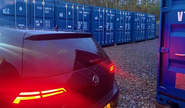 a car reversing up to a storage unit