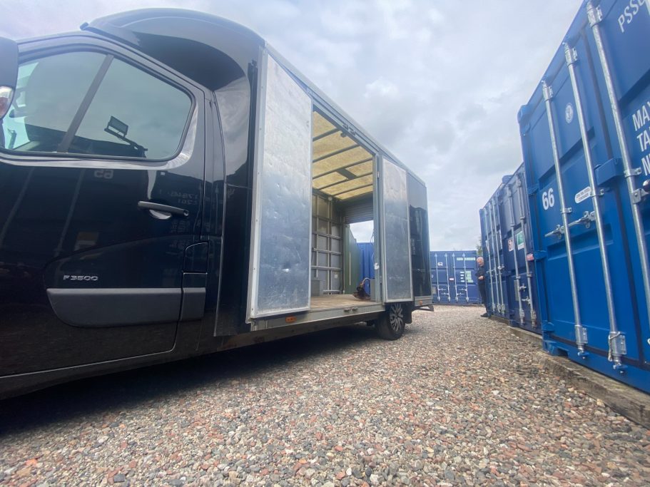 van unloading on a shipping container storage depot