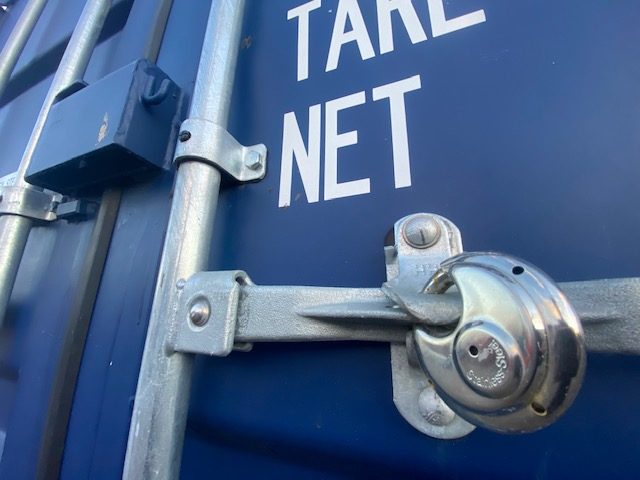 a cylinder type padlock locking a shipping container