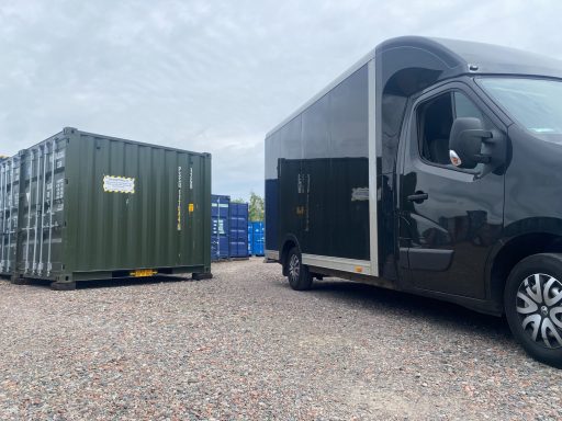 black van driving onto a storage facility