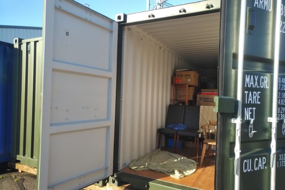 inside of a shipping container containing household furniture