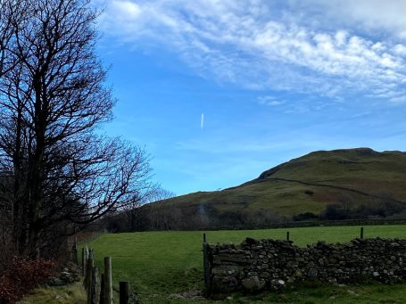 field at keswick with blue sky