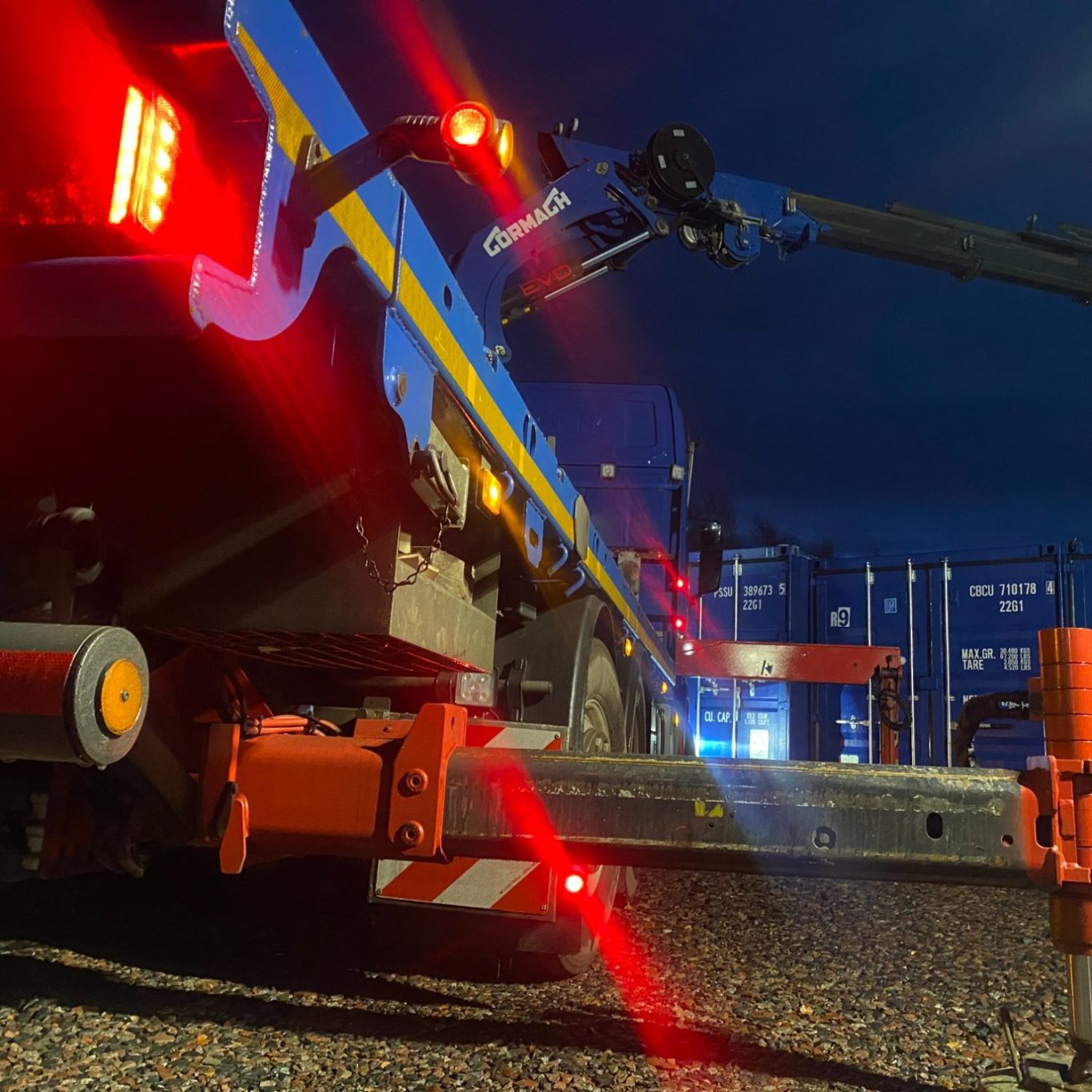 lorry moving shipping containers at night